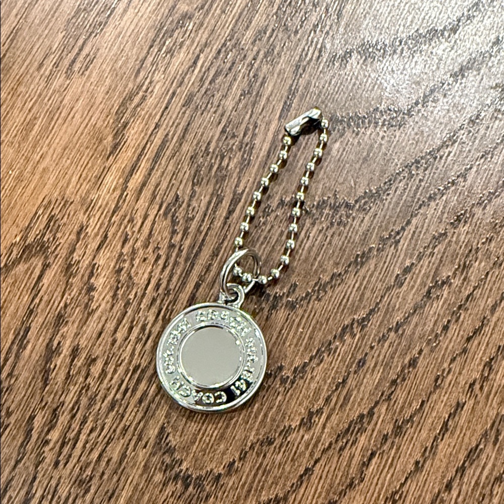 Coach silver medallion hang tag